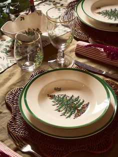 the place setting is decorated with green and white dishes