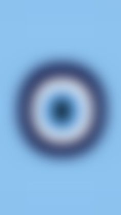 an image of a blue and white circular in the sky with only one eye visible