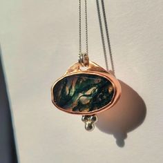 ✺ This mesmerizing moss agate stone has been set in copper. A trio of sterling silver balls add a subtle accent. It is hung from a delicate 18-inch sterling silver chain. The pendant has been coated in a specialized jewelry lacquer that greatly minimizes any minor scratches or future oxidization that may naturally occur. ✺ M A T E R I A L S : * fine 18-inch sterling silver chain + clasp * sterling silver, copper * moss agate A B O U T * T H I S * N E C K L A C E : This .925 sterling silver, copp Moss Agate Necklace, Ethereal Jewelry, Moss Agate Stone, Earthy Jewelry, Mixed Metal Jewelry, Copper Pendant, Creating Jewelry, Brass Necklace, Agate Necklace