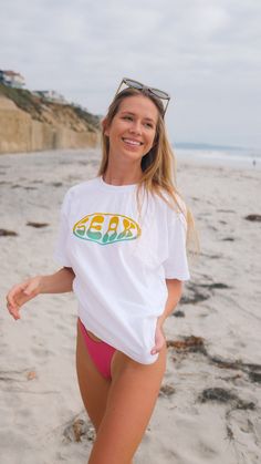 Embrace vintage vibes with our Retro Circle Tee from Seak the Label. This short sleeve tee features a captivating retro circle design, embodying the essence of sun-soaked days and coastal living. Whether you're chasing waves or the sunset, wear the spirit of SEAK. * 100% ring-spun cotton * Garment-dyed * Relaxed fit * 7/8″ double-needle topstitched collar * Twill-taped neck and shoulders for extra durability * Double-needle armhole, sleeve, and bottom hems This product is made especially for you Smurf Shirts Tees, 90s Inspired Short Sleeve Summer T-shirt, 90s Inspired Screen Print Summer T-shirt, 90s Cotton T-shirt For Beach, 90s Cotton T-shirt For The Beach, 90s Style Cotton T-shirt For Beach, 90s Inspired Pre-shrunk Summer T-shirt, Oversized 90s Style Summer T-shirt, Vintage White Tops For Beach Season