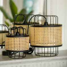 four birdcages sitting on top of a shelf