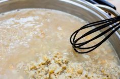 a metal bowl filled with food and whisk