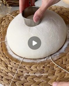 someone is making something out of bread on top of a basket with twine of thread