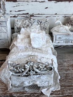 an old fashioned bed with white lace on it