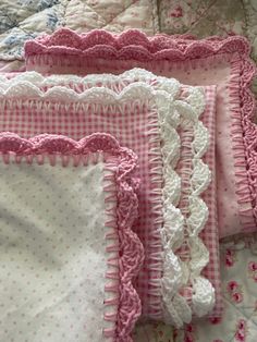 three pink and white bedspreads with ruffles on them are laying next to each other