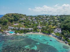 an aerial view of the resort and surrounding area with clear blue water, surrounded by lush green trees