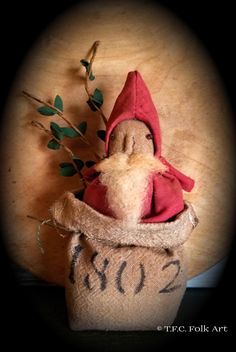 a gnome in a sack with some plants