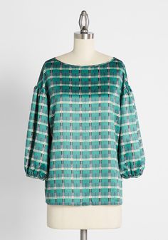 Glow on the go in this vintage-inspired top patterned with a green, white, and black art deco-style plaid. Featuring a scoop neck and billowing peasant sleeves, this fabulously flowy retro shirt by Hutch is an elegant blast from the past ! Polyester. Hand wash. Imported Fabric provides stretch. S=24.5 inches Length 1X=28 inches Length | Hutch Preened Top in Green Plaid, Size Small Vintage Style Swimwear, Casual Dresses Plus Size, Midi Dress Plus Size, Vintage Swimwear, Blast From The Past, Chic Blouses, Plus Size Outerwear, Casual Rompers, Midi Dress Casual