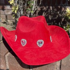 The Ultimate Statement-Maker: Our Bright Red Heart Jeweled Cowgirl Hat! This Cute Red Cowgirl Hat Has Rhinestone Embellished Jeweled Pave Hearts, Faux Suede Material, A Western Fit And 3.75" Brim. Accessorize Any Outfit With This Bright And Bold Look! Size & Fit Information: 3.75" Brim Details & Materials: Western Style Hat Bright Red Color Faux Suede Material Jeweled Rhinestone Pave Heart Trim 100% Polyester Spot Clean With Damp Towel Red Western-style Party Hat, Red Western Style Party Hat, Red Cowgirl Hat, Cowgirl Hat, Cowgirl Hats, Suede Material, Western Style, Bright Red, Red Heart