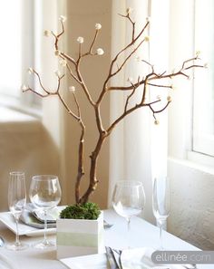 an image of a table setting with wine glasses and a tree in the center, which reads diy spiral rose branch