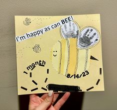 a person holding up a card with the words i'm happy as can bee