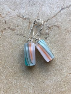 Beach inspired fused glass earrings with colors turquoise, white and coral. The earrings are light weight and approximately .25" x .75" with a total drop length of approximately 1.75" on kidney ear wires. Ear wires are hypoallergenic, sterling silver plated brass.  Other pieces available separately.     Caring for fused glass jewelry: To clean, use a soft cloth. Do not use harsh chemicals to clean. Should not be submerged in water, and should be removed when bathing. While fused glass is much stronger, use care when handling as can still break if dropped on hard surface.  Please contact me with any questions, changes or modifications.  Thank you so much for stopping at my shop! Fusing Glas, Fused Glass Earrings, Fused Glass Jewelry, Beach Inspired, Etsy Earrings Dangle, Glass Earrings, Earrings Etsy, Glass Jewelry, Fused Glass