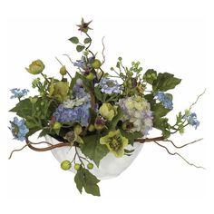 a white vase filled with lots of flowers and greenery on top of a table