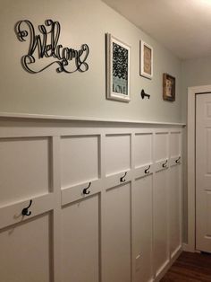 a hallway with several white lockers and some pictures on the wall above them that say welcome