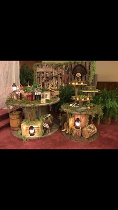 the table is made out of wood and has moss growing on it, along with other decorations