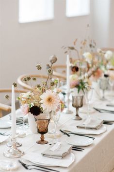 the table is set with white and black place settings