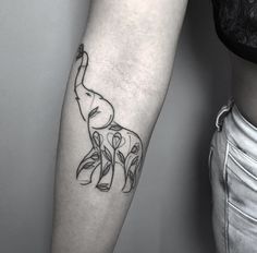 an elephant tattoo on the right arm and leg is shown in black ink with white outline