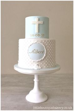 a white and blue cake with a cross on top