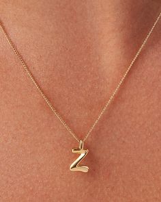 A best seller made better. Available in A through Z, these monograms are now available in a water-durable finish, with the option to strand multiple letters on a single chain. These custom letter pendants embrace a sculptural curve and smooth shape. Each letter is strung along a delicate curb chain that is adjustable to two different lengths (17"or 19") for your preferred fit. Finished in high-polish gold. To add an extra letter to your chain, see the Monogram Pendant. 14K gold-plated steellobst Chic Gold Initial Pendant Chain Necklace, Initial Necklace Gold Letters Pendants, Yellow Gold Initial Pendant Chain Necklace, Gold Necklace Letter, Z Necklace, Z Pendant, Z Necklace Letter Gold, Elegant Gold-tone Initial Pendant Chain Necklace, E Necklace