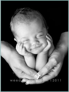 a black and white photo of a baby in its mother's hands with the caption welcome home 2011