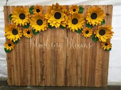 a wooden sign with sunflowers on it