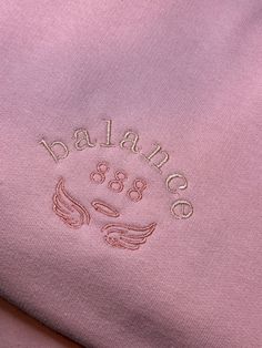 "These angel number sweatshirts are the perfect addition to any outfit. The jumpers read \"balance 888\" and are a baby pink colour with pink and blush lettering. They have been embroidered using a machine so have a professional finish. The design is 7.5 x 5cm and is positioned on the left side of the chest (if you are wearing the jumper). The sweatshirts are really good quality and comfortable (lined with brushed fleece). They're loose fitting as the sizing is unisex. They are £25 including free second class postage and the average processing time is 1-2 weeks. If you would like this design in another colour or size feel free to drop us a message and we will create a private listing for you! It is always safest to hand-wash the garments or if machine washing we advise to wash at 30 degree Pink Embroidered Text Crew Neck T-shirt, Angel Number Sweatshirt, Pink Crew Neck T-shirt With Embroidered Text, Pink Embroidered Relaxed Fit Sweatshirt, Pink Embroidered Logo Sweatshirt, Relaxed Fit, Baby Pink Colour, Rose Pale, Embroidered Crewneck, Oversized Style