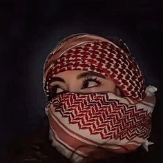 a woman wearing a red and white patterned head scarf with her eyes closed to the side