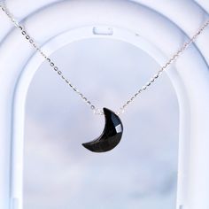 A subtly beautiful necklace for the minimalist who appreciates healing gemstones. This handmade pendant necklace features a carved black onyx crescent moon suspended from a delicate sterling silver chain - simple yet striking. Black onyx, a calming stone, lends an air of serenity when worn close to the heart. The sterling silver chain is cool and lightweight, ideal for everyday wear that doesn't demand attention yet flatters with understated elegance. An effortlessly chic accessory for the moder Black Moon Phase Round Pendant Necklace, Black Moon Phase Round Pendant Jewelry, Black Moon Charm Round Pendant Jewelry, Black Necklace With Moon Charm, Black Round Necklace With Moon Charm, Black Moon Phase Necklace For Gift, Black Round Pendant Jewelry With Moon Charm, Black Moon Shaped Jewelry Gift, Black Moon Charm Jewelry For Gift