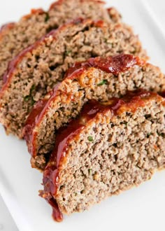 sliced meatloaf on a white plate with ketchup