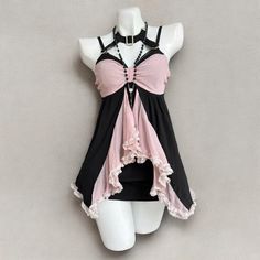 a mannequin wearing a pink and black top with ruffles on it