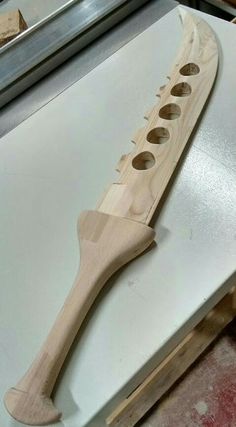 a wooden instrument with four holes in it