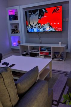 a living room with couches and a flat screen tv in it's center