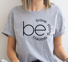 "Be Brave Be Strong Be Fearless Shirt, Funny T-Shirt, Inspirational Shirt, Motivational Tshirt, Positivity Shirt, Gift Oversized T-Shirt DETAIL For printing, we use Bella Canvas and Gildan SoftStyle brand shirts, which are the best in the industry. *Bella Canvas -unisex size -4.2 oz. -Solid colors are 100% Combed Cotton and Ring-Spun Cotton. -Athletic Heather 90% Combed and Ring-Spun Cotton, 10% Polyester -All Heather CVC Colors 52% Combed and Ring-Spun, 48% Polyester *Gildan SoftStyle -unisex s Women’s Tshirt Ideas, One Word Shirts, Motivational Tshirts Inspiration, Positive Quotes For Shirts, Inspirational Shirt Ideas, Positive Tshirt Ideas, Motivational Tshirt Designs, Positive Shirts Graphic Tees, Shirt Quotes Inspirational