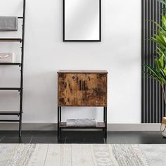 a wooden cabinet sitting in front of a mirror next to a tall black metal shelf