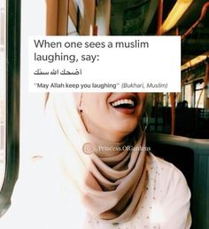 a woman is smiling and wearing a scarf on her head while sitting in a bus