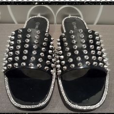 Silver Spikes With Rhinestones Around The Edge Comes With Original Box Flat Party Sandals With Studded Rubber Outsoles, Flat Sandals With Studded Rubber Outsoles For Party, Black Studded Sandals For The Beach, Black Bling Sandals For Summer, Black Open Toe Sandals With Silver Studs, Flat Sandals With Spikes For Party, Black Sandals With Silver Studs For Parties, Rhinestone Slides, Sparkle Sandals