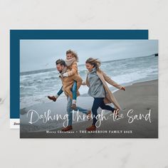 a christmas card with two girls running on the beach