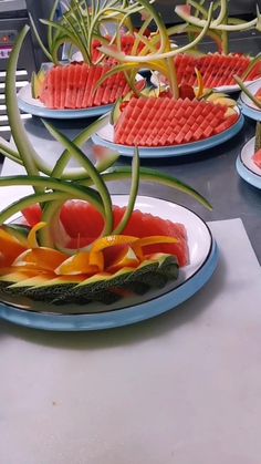 a person cutting up a piece of watermelon on top of a table with waffles in the background