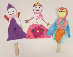 three children's handmade paper dolls on toothpicks