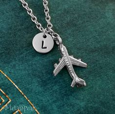 "This listing is for a personalized airplane pendant keychain with a hand-stamped initial charm. We can also make this into a necklace instead, just choose your chain length from the drop-down menu. You will be able to choose between a key ring, link chain, bangle bracelet, or ball chain when checking out. You will also be able to choose your initial! :) **Please see the second picture for scale. This is a SMALL and lightweight charm. The initial charm measures 3/8\". - - - - - - Sign up for our Gift Long Distance Relationship, Airplane Jewelry, Airplane Pendant, Plane Necklace, Airplane Necklace, Airplane Gifts, Small Plane, Long Distance Relationship Gift, Distance Relationship Gifts