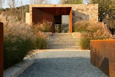 an entrance to a house with stone walls and steps