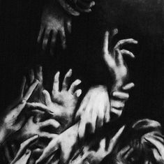 a black and white photo of many hands reaching for something