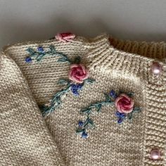 a close up of a sweater with flowers on it