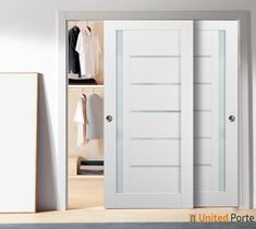 an open closet door with clothes hanging on the shelves