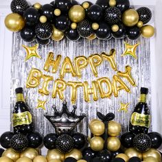 a birthday party with black and gold balloons