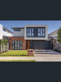 a large house with two car garages in the front and one side of it