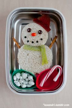 a plastic container filled with food and a snowman