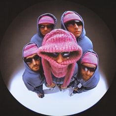 a group of men wearing pink hats and sunglasses on top of a white plate with a black background