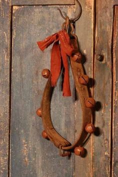 a wooden door with a metal ring and tassels