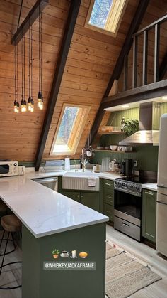 a kitchen with green cabinets and white counter tops